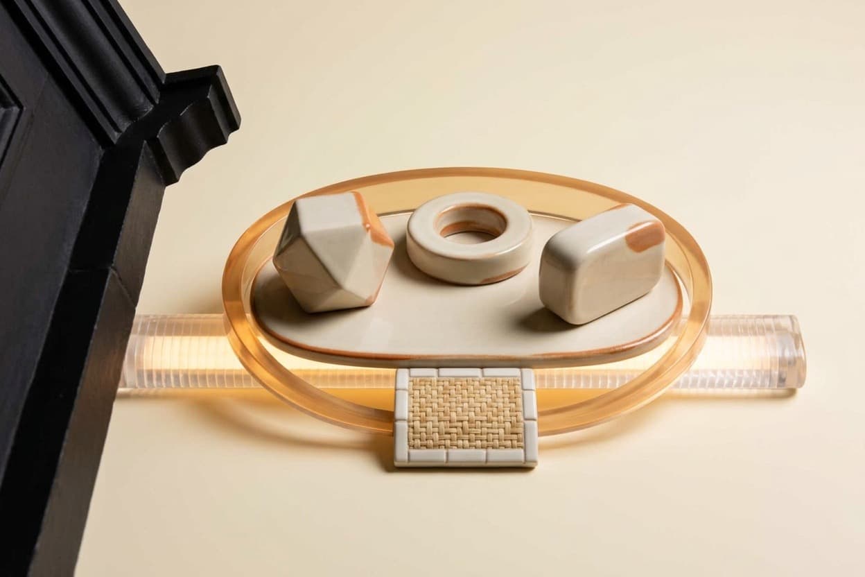 Three geometric role modules on a shared ceramic base inside a translucent access boundary.